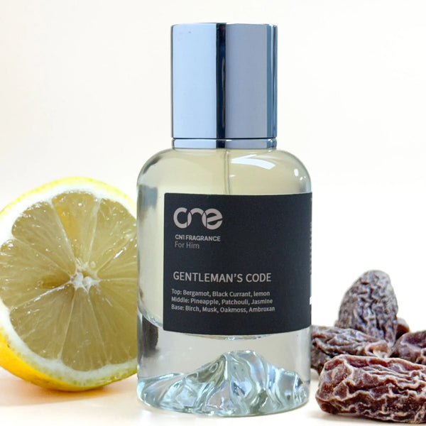 Bottle of 'Gentleman's Code' fragrance with a lemon and dried fruits on a white background