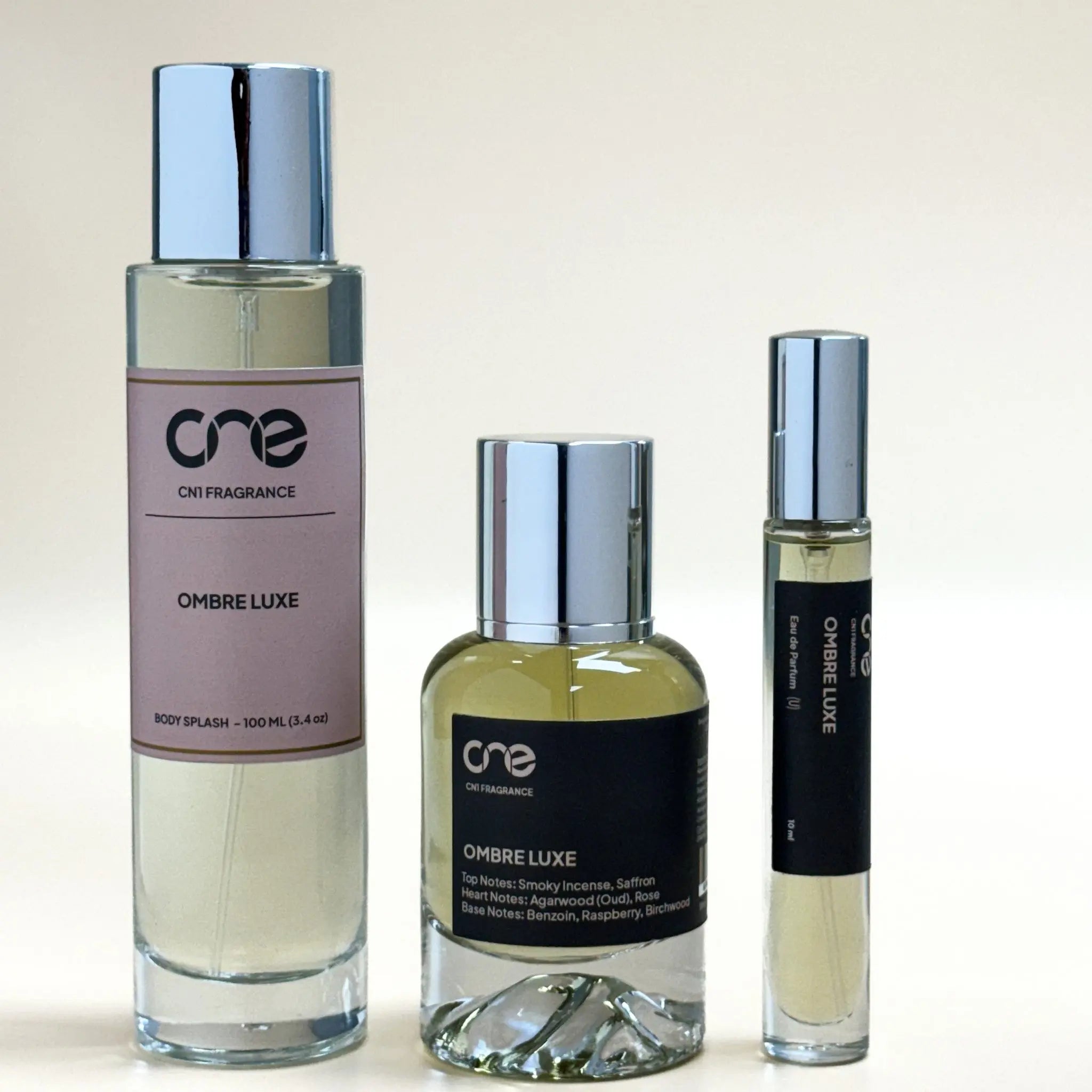 Three bottles of Ombre Luxe perfume by one on a light background